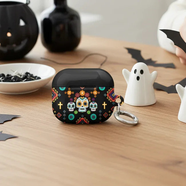 Person crafting Halloween decorations on a table with a decorative case and small ghost figures.